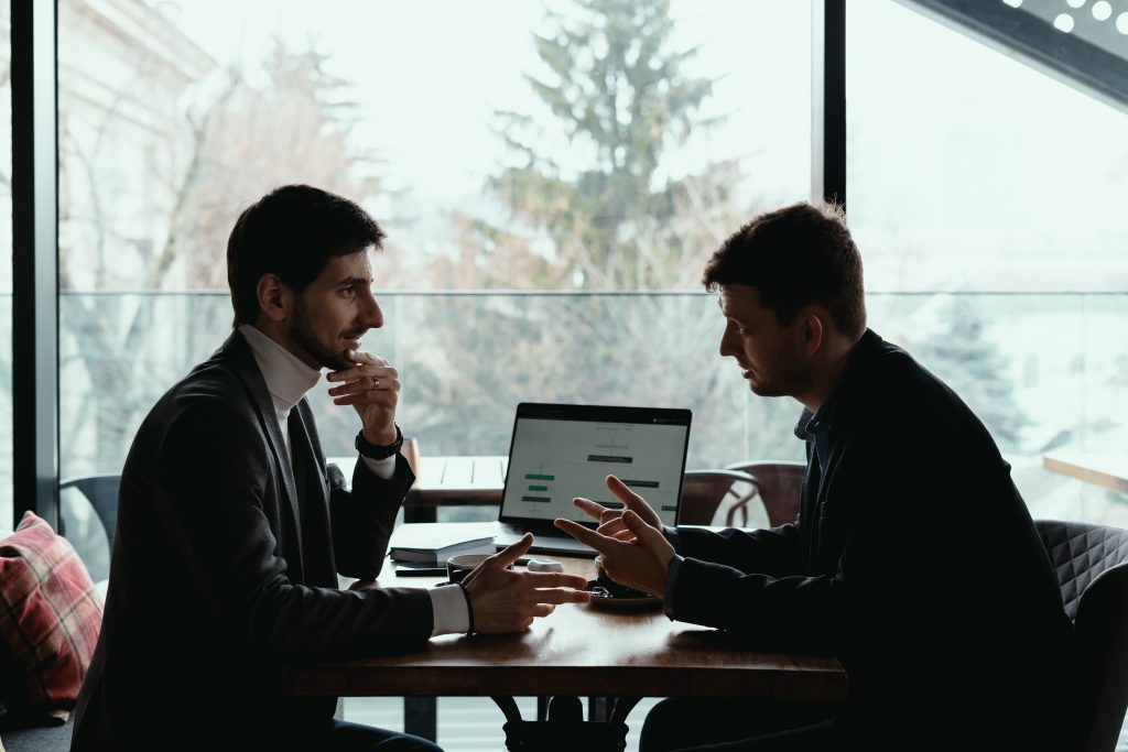 two young businessman having a successful meeting at restaurant.